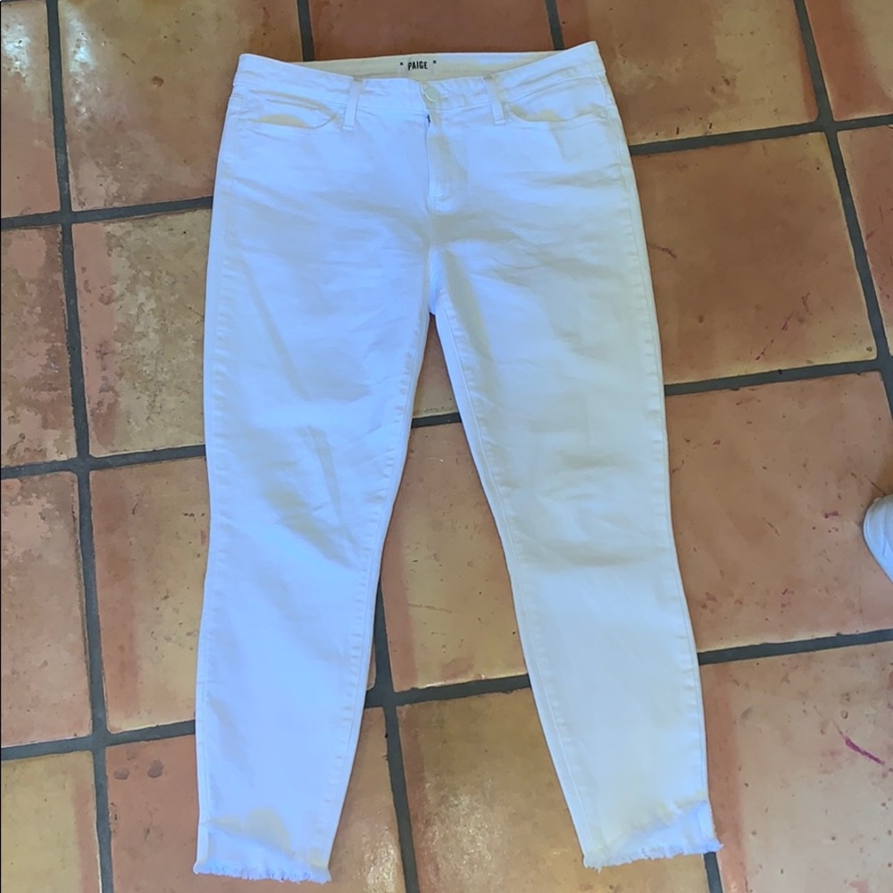 white paige jeans with tattered bottoms